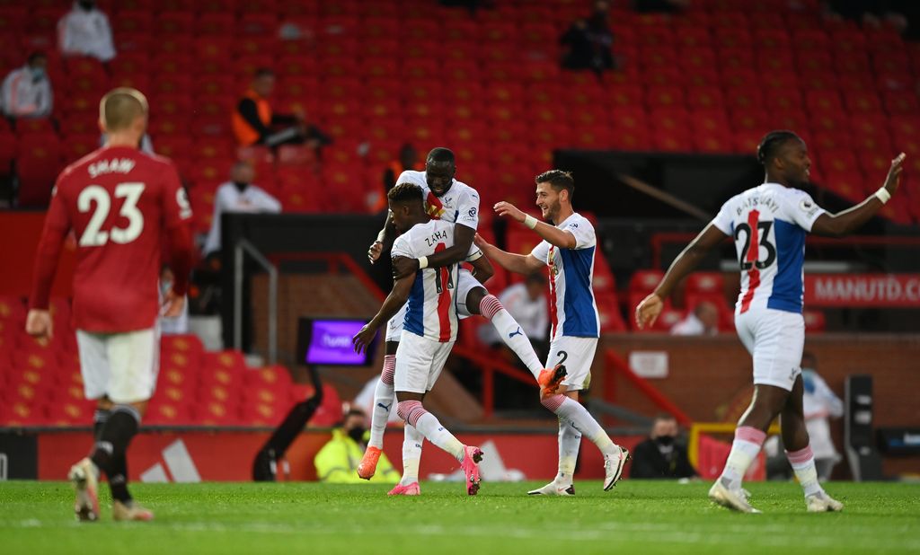 MANCHESTER, ENGLAND - SEPTEMBER 19: Wilfried Zaha of Crystal Palace celebrates with teammates after scoring his team's third goal  during the Premier League match between Manchester United and Crystal Palace at Old Trafford on September 19, 2020 in Manchester, England. (Photo by Shaun Botterill/Getty Images)
