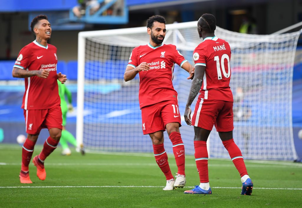 LONDON, ENGLAND - SEPTEMBER 20: Liverpool's Sadio Mane celebrates with teammate Mohamed Salah after scoring his team's second goal during the Premier League match between Chelsea and Liverpool at Stamford Bridge on September 20, 2020 in London England.  (Photo by Michael Regan / Getty Images)