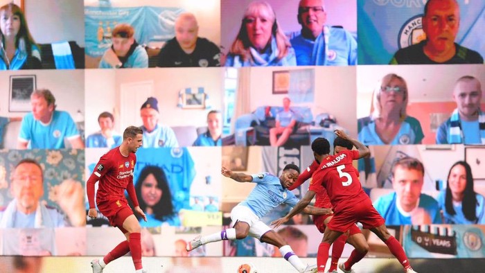 MANCHESTER, ENGLAND - JULY 02: Raheem Sterling of Manchester City is fouled in the penalty area by Joe Gomez of Liverpool as fans watch on the big screen during the Premier League match between Manchester City and Liverpool FC at Etihad Stadium on July 02, 2020 in Manchester, England. Football Stadiums around Europe remain empty due to the Coronavirus Pandemic as Government social distancing laws prohibit fans inside venues resulting in games being played behind closed doors. (Photo by Laurence Griffiths/Getty Images)