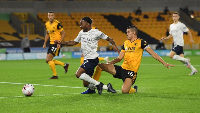 WOLVERHAMPTON, ENGLAND - SEPTEMBER 21: Conor Coady of Wolverhampton Wanderers makes a challenge on Raheem Sterling of Manchester City during the Premier League match between Wolverhampton Wanderers and Manchester City at Molineux on September 21, 2020 in Wolverhampton, England. (Photo by Stu Forster/Getty Images)