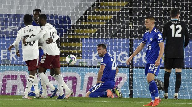 Leicester's Christian Fuchs, center, reacts after scoring an own goal during the English League Cup 3rd round soccer match between Leicester City and Arsenal at the King Power Stadium in Leicester, England, Wednesday, Sept. 23, 2020. (AP Photo/Rui Vieira, Pool)