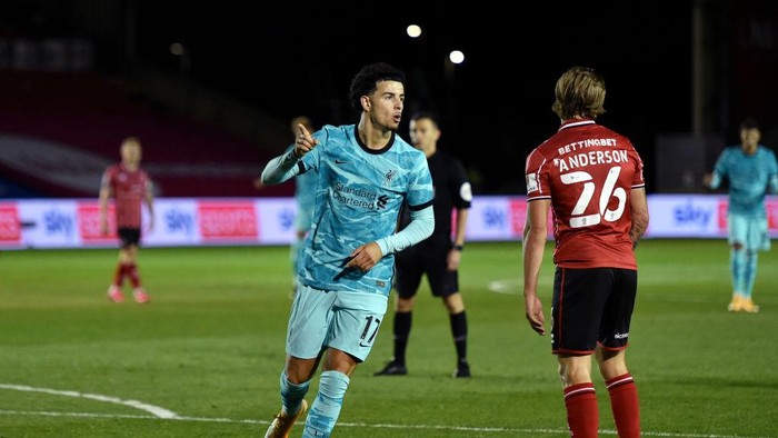 LINCOLN, ENGLAND - SEPTEMBER 24: Curtis Jones of Liverpool  celebrates after scoring his teams first goal during the Carabao Cup third round match between Lincoln City and Liverpool at Sincil Bank Stadium on September 24, 2020 in Lincoln, England. Football Stadiums around United Kingdom remain empty due to the Coronavirus Pandemic as Government social distancing laws prohibit fans inside venues resulting in fixtures being played behind closed doors. (Photo by Peter Powell -