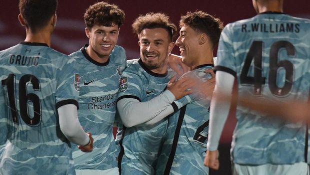 Liverpool's Xherdan Shaqiri, at centre, celebrates with teammates after scoring the opening goal of the game during the English League Cup third round soccer match between Lincoln City and Liverpool at the LNER stadium, Lincoln, England, Thursday, Sept. 24, 2020. (Peter Powell, Pool via AP)