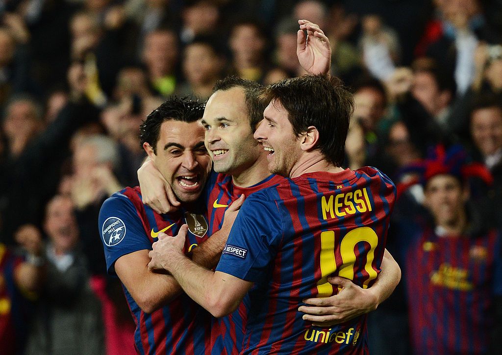 BARCELONA, SPAIN - APRIL 03:  Andres Iniesta (C) of FC Barcelona celebrates scoring with his teammates Lionel Messi (R) and Xavi Hernandez during the Champions League quarter-final second leg match between FC Barcelona and AC Milan at the Camp Nou stadium on April 3, 2012 in Barcelona, Spain.  (Photo by Jasper Juinen/Getty Images)