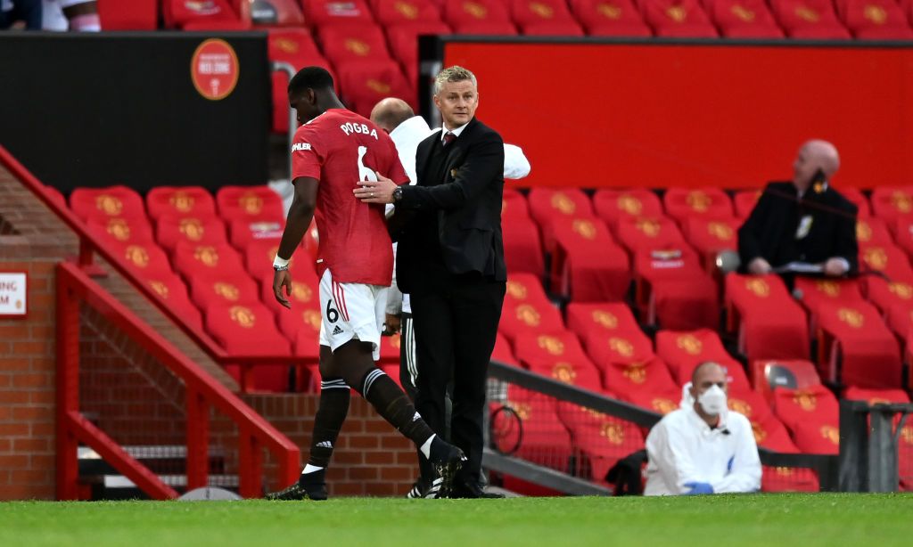 MANCHESTER, ENGLAND - SEPTEMBER 19: Ole Gunnar Solskjaer, Manager of Manchester United greets Paul Pogba of Manchester United as he is substituted off during the Premier League match between Manchester United and Crystal Palace at Old Trafford on September 19, 2020 in Manchester, England. (Photo by Shaun Botterill/Getty Images)