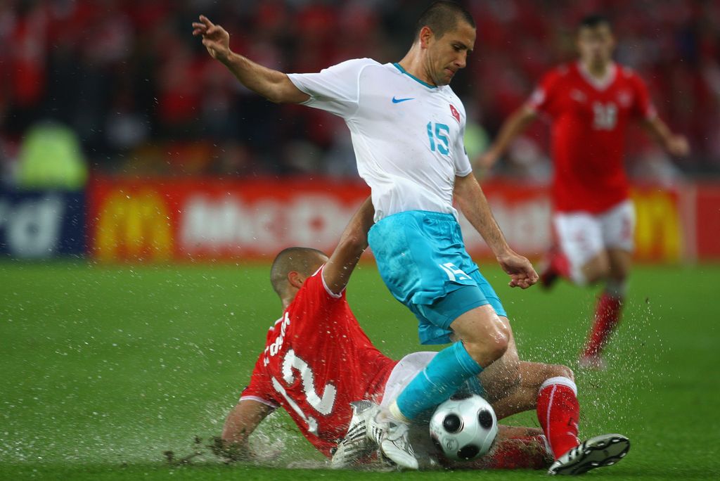 BASEL, SWITZERLAND - JUNE 11: Eren Derdiyok of Switzerland tackles Emre Asik of Turkey during the UEFA EURO 2008 Group A match between Switzerland and Turkey at St. Jakob-Park on June 11, 2008 in Basel, Switzerland. (Photo by Laurence Griffiths/Getty Images)