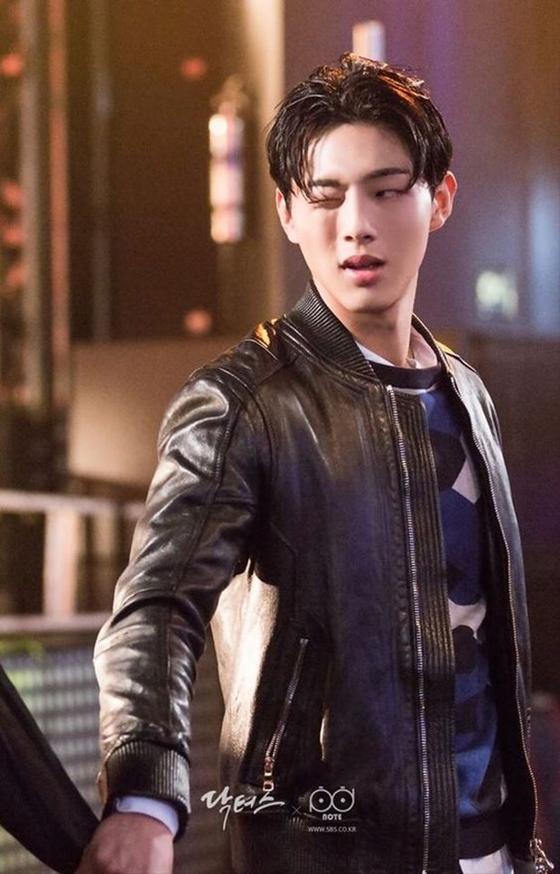 Memberikan kesan pesona anak laki-laki nakal dengan jelas dengan tampilan rambut gel dan mengendarai motor.