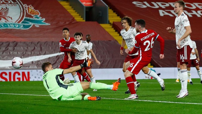 LIVERPOOL, ENGLAND - SEPTEMBER 28: Andy Robertson of Liverpool scores his sides second goal during the Premier League match between Liverpool and Arsenal at Anfield on September 28, 2020 in Liverpool, England. Sporting stadiums around the UK remain under strict restrictions due to the Coronavirus Pandemic as Government social distancing laws prohibit fans inside venues resulting in games being played behind closed doors. (Photo by Jason Cairnduff - Pool/Getty Images)