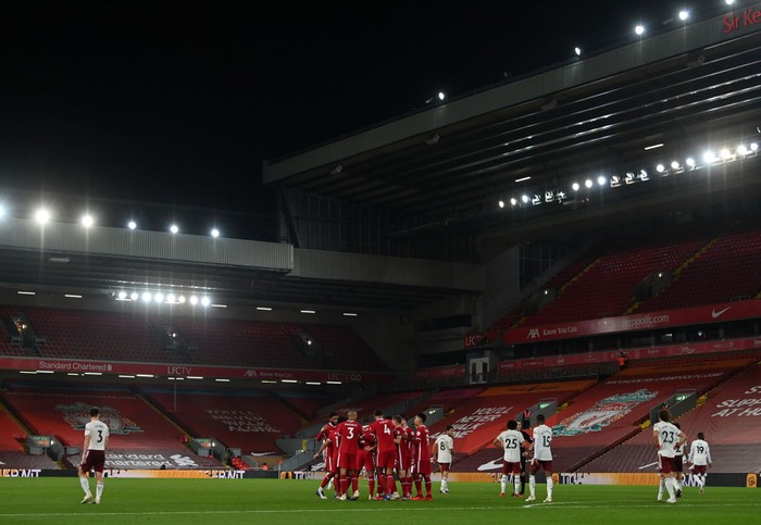 LIVERPOOL, ENGLAND - SEPTEMBER 28: A general view inside the stadium as Diogo Jota of Liverpool celebrates with teammates after scoring his sides third goal during the Premier League match between Liverpool and Arsenal at Anfield on September 28, 2020 in Liverpool, England. Sporting stadiums around the UK remain under strict restrictions due to the Coronavirus Pandemic as Government social distancing laws prohibit fans inside venues resulting in games being played behind closed doors. (Photo by Paul Ellis - Pool/Getty Images)