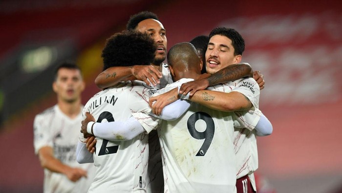 LIVERPOOL, ENGLAND - SEPTEMBER 28: Alexandre Lacazette of Arsenal celebrates with teammates after scoring his sides first goal during the Premier League match between Liverpool and Arsenal at Anfield on September 28, 2020 in Liverpool, England. Sporting stadiums around the UK remain under strict restrictions due to the Coronavirus Pandemic as Government social distancing laws prohibit fans inside venues resulting in games being played behind closed doors. (Photo by Paul Ellis - Pool/Getty Images)