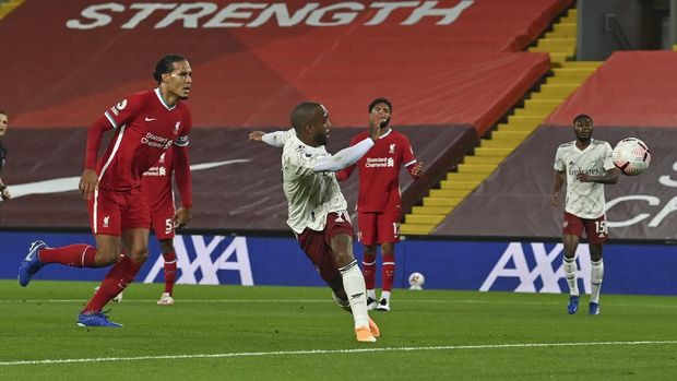 Arsenal's Alexandre Lacazette, centre, scores his team's first goal during the English Premier League soccer match between Liverpool and Arsenal at Anfield in Liverpool, England, Monday, Sept. 28, 2020. (Paul Ellis/Pool via AP)