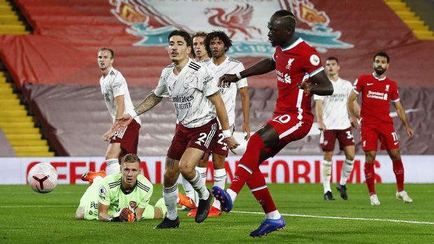 Liverpool's Sadio Mane scores his team's first goal during the English Premier League soccer match between Liverpool and Arsenal at Anfield in Liverpool, England, Monday, Sept. 28, 2020. (Jason Cairnduff/Pool via AP)