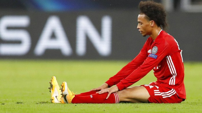 Bayerns Leroy Sane sits on the pitch during the UEFA Super Cup soccer match between Bayern Munich and Sevilla at the Puskas Arena in Budapest, Hungary, Thursday, Sept. 24, 2020. (AP Photo/Laszlo Balogh, Pool)