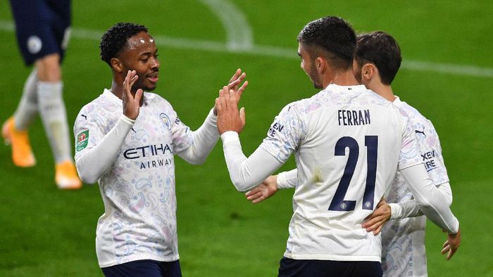 Manchester City BURNLEY, ENGLAND - SEPTEMBER 30: Ferran Torres of Manchester City celebrates with teammates after scoring his sides third goal during the Carabao Cup fourth round match between Burnley and Manchester City at Turf Moor on September 30, 2020 in Burnley, England. Football Stadiums around United Kingdom remain empty due to the Coronavirus Pandemic as Government social distancing laws prohibit fans inside venues resulting in fixtures being played behind closed doors. (Photo by Paul Ellis - Pool/Getty Images)