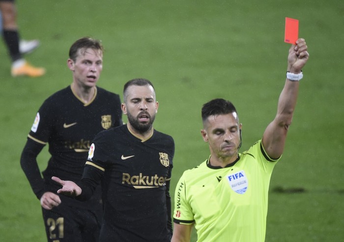 Barcelona's Spanish defender Jordi Alba (2L) reacts to Spanish referee Carlos del Cerro presenting a red card to Barcelona's French defender Clement Lenglet (out of frame) during the Spanish league football match RC Celta de Vigo against FC Barcelona at the Balaidos stadium in Vigo on October 1, 2020. (Photo by MIGUEL RIOPA / AFP)