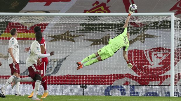 Arsenal's goalkeeper Bernd Leno makes a save during the English League Cup fourth round soccer match between Liverpool and Arsenal at Anfield, Liverpool, England, Thursday, Oct. 1, 2020. (Peter Byrne/Pool via AP)