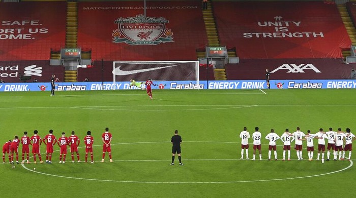 Arsenals goalkeeper Bernd Leno saves a penalty from Liverpools Divock Origi during the English League Cup fourth round soccer match between Liverpool and Arsenal at Anfield, Liverpool, England, Thursday, Oct. 1, 2020. (Laurence Griffiths/Pool via AP)