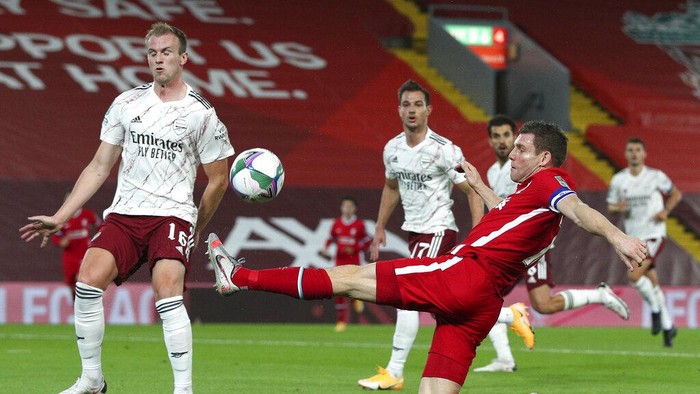 Liverpools James Milner reaches out for the ball during the English League Cup fourth round soccer match between Liverpool and Arsenal at Anfield, Liverpool, England, Thursday, Oct. 1, 2020. (Peter Byrne/Pool via AP)