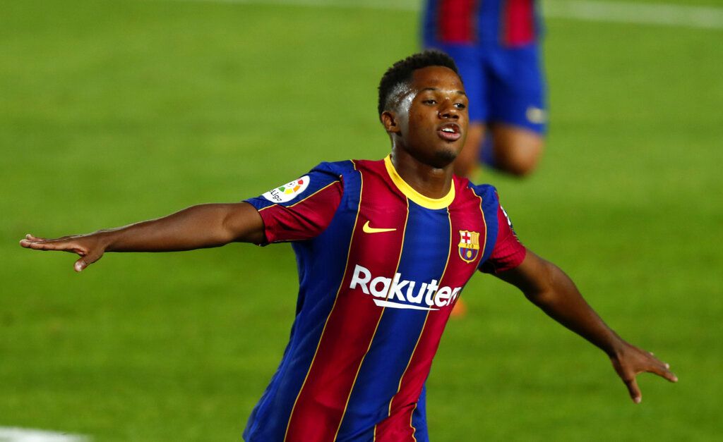 Barcelona's Ansu Fati celebrates scoring the opening goal during the Spanish La Liga soccer match between FC Barcelona and Villareal FC at the Camp Nou stadium in Barcelona, Spain, Sunday, Sept. 27, 2020. (AP Photo/Joan Monfort)