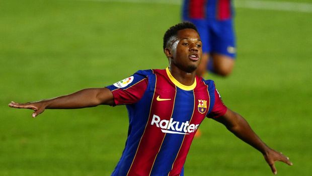 Barcelona's Ansu Fati celebrates scoring the opening goal during the Spanish La Liga soccer match between FC Barcelona and Villareal FC at the Camp Nou stadium in Barcelona, Spain, Sunday, Sept. 27, 2020. (AP Photo/Joan Monfort)