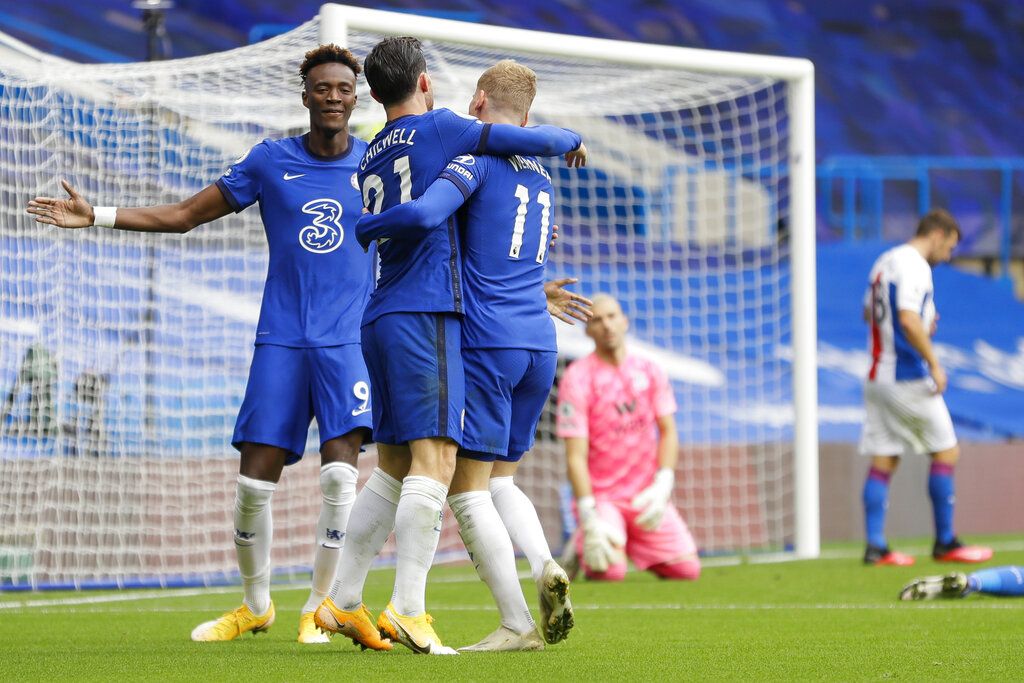 Chelsea's Ben Chilwell, center, celebrates with his teammates Tammy Abraham, left, and Timo Werner after he scored his side's first goalduring the English Premier League soccer match between Chelsea and Crystal Palace at Stamford Bridge stadium in London, Saturday, Oct. 3, 2020. (AP Photo/Kirsty Wigglesworth, Pool)