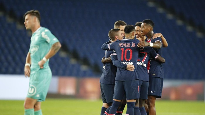 PSG players celebrate after Idrissa Gueye scored their sides 5th goal during the French League One soccer match between Paris Saint-Germain and Angers at the Parc des Princes in Paris, France, Friday, Oct. 2, 2020. (AP Photo/Francois Mori)