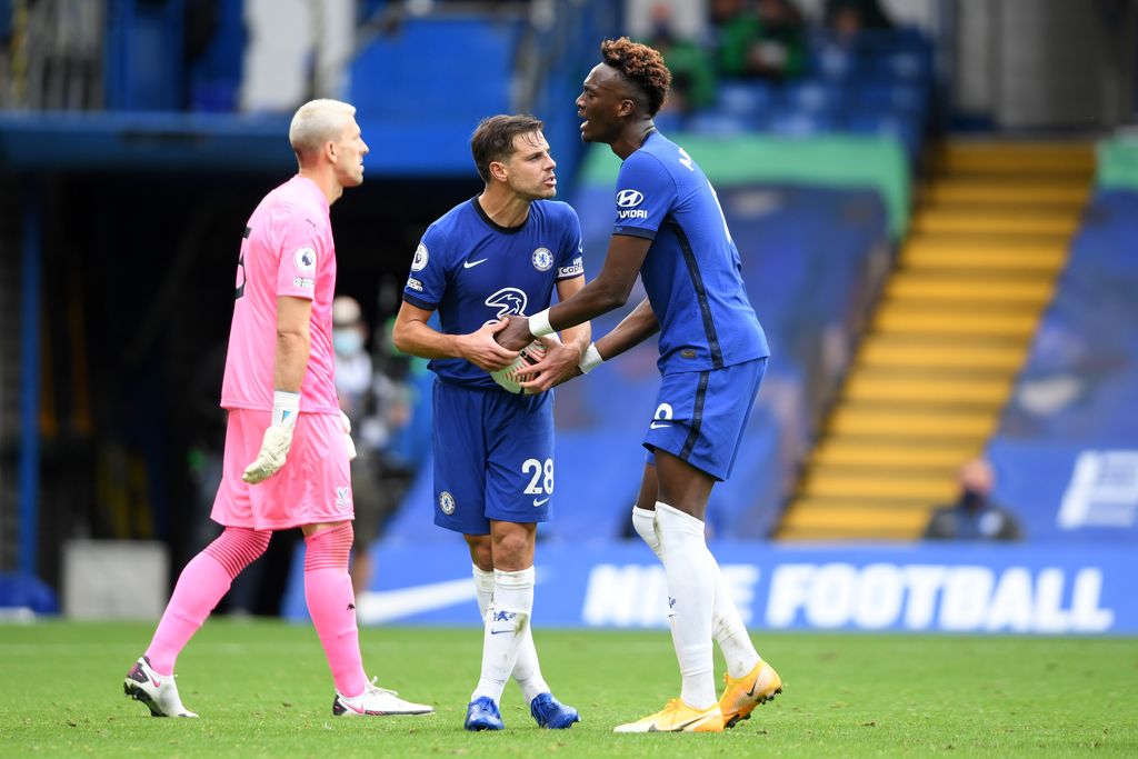 LONDON, ENGLAND - OCTOBER 03: Cesar Azpilicueta and Tammy Abraham of Chelsea argue over the ball during the Premier League match between Chelsea and Crystal Palace at Stamford Bridge on October 03, 2020 in London, England. Sporting stadiums around the UK remain under strict restrictions due to the Coronavirus Pandemic as Government social distancing laws prohibit fans inside venues resulting in games being played behind closed doors. (Photo by Mike Hewitt/Getty Images)