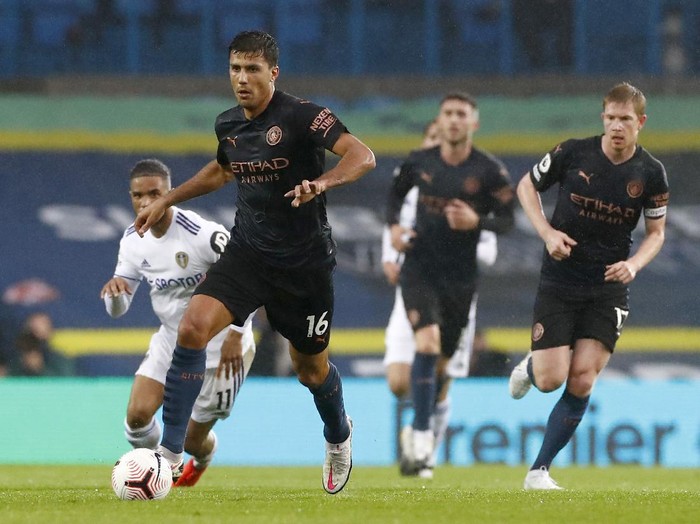 Manchester Citys Rodrigo, left, runs with the ball during the English Premier League soccer match between Leeds United and Manchester City at Elland Road in Leeds, England, Saturday, Oct. 3, 2020. (Jason Cairnduff/Pool via AP)