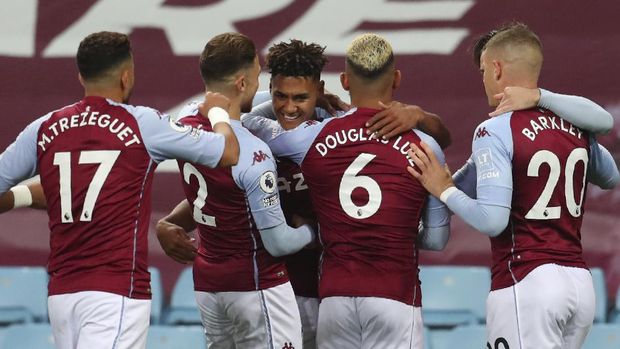 Aston Villa's Ollie Watkins, center, celebrates with his teammates after scoring his side's opening goal during the English Premier League soccer match between Aston Villa and Liverpool at the Villa Park stadium in Birmingham, England, Sunday, Oct. 4, 2020. (Cath Ivill/Pool via AP)