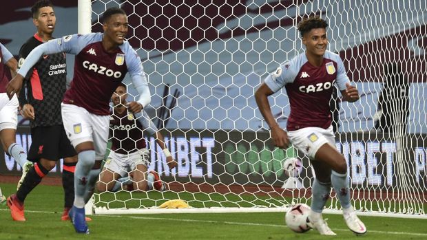Aston Villa's Ollie Watkins, right, celebrates after scoring his side's fourth goal during the English Premier League soccer match between Aston Villa and Liverpool at the Villa Park stadium in Birmingham, England, Sunday, Oct. 4, 2020. (AP Photo/Rui Vieira, Pool)
