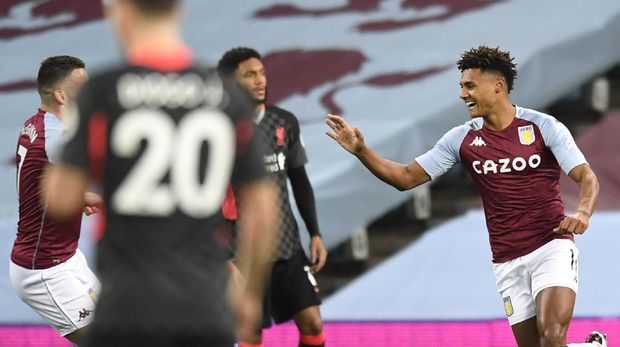 Aston Villa's Ollie Watkins, right, celebrates with his teammates after scoring his side's opening goal during the English Premier League soccer match between Aston Villa and Liverpool at the Villa Park stadium in Birmingham, England, Sunday, Oct. 4, 2020. (Cath Ivill/Pool via AP)