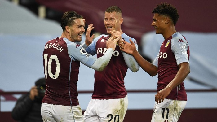 BIRMINGHAM, ENGLAND - OCTOBER 04: Jack Grealish of Aston Villa celebrates with Ross Barkley of Aston Villa and Ollie Watkins of Aston Villa  after he scores his sides 7th goal during the Premier League match between Aston Villa and Liverpool at Villa Park on October 04, 2020 in Birmingham, England. Sporting stadiums around the UK remain under strict restrictions due to the Coronavirus Pandemic as Government social distancing laws prohibit fans inside venues resulting in games being played behind closed doors. (Photo by Peter Powell - Pool/Getty Images)