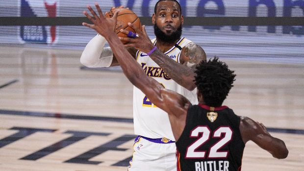 Los Angeles Lakers' LeBron James (23) looks to pass the ball against Miami Heat's Jimmy Butler (22) during the first half in Game 3 of basketball's NBA Finals, Sunday, Oct. 4, 2020, in Lake Buena Vista, Fla. (AP Photo/Mark J. Terrill)