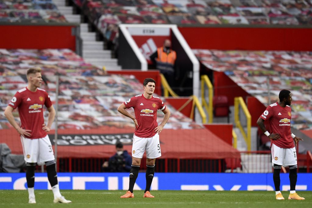 Manchester United's Harry Maguire, center, reacts after Tottenham scored his fifth goal during the English Premier League soccer match between Manchester United and Tottenham Hotspur at Old Trafford in Manchester, England, Sunday, October 4, 2020 (Oli Scarff / Pool via AP).  )