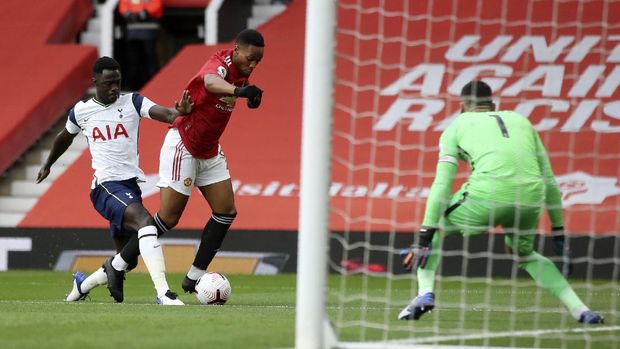 Tottenham's Davinson Sanchez, left, fouls Manchester United's Anthony Martial in the box to give away a penalty shot during the English Premier League soccer match between Manchester United and Tottenham Hotspur at Old Trafford in Manchester, England, Sunday, Oct. 4, 2020. (Carl Recine/Pool via AP)