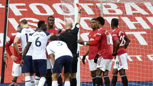 Referee Anthony Taylor shows a red card to Manchester United's Anthony Martial, 3rd right, during the English Premier League soccer match between Manchester United and Tottenham Hotspur at Old Trafford in Manchester, England, Sunday, Oct. 4, 2020. (Carl Recine/Pool via AP)