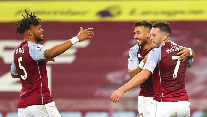 Aston Villas John McGinn, right, celebrates after scoring his sides third goal during the English Premier League soccer match between Aston Villa and Liverpool at the Villa Park stadium in Birmingham, England, Sunday, Oct. 4, 2020. (Cath Ivill/Pool via AP)