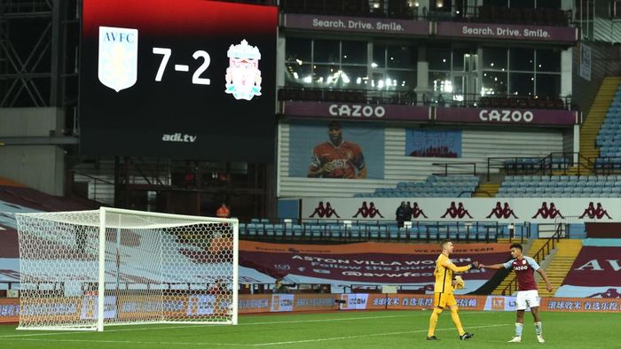 Aston Villa vs Liverpool BIRMINGHAM, ENGLAND - OCTOBER 04: Adrian of Liverpool shakes hands with Ollie Watkins of Aston Villa as the final score of 7-2 is seen on the big screen behind during the Premier League match between Aston Villa and Liverpool at Villa Park on October 04, 2020 in Birmingham, England. Sporting stadiums around the UK remain under strict restrictions due to the Coronavirus Pandemic as Government social distancing laws prohibit fans inside venues resulting in games being played behind closed doors. (Photo by Peter Powell - Pool/Getty Images)