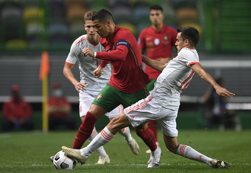 LISBON, PORTUGAL - OCTOBER 07:  Cristiano Ronaldo, Captain of Portugal is tackled by Sergio Reguilon of Spain during the international friendly match between Portugal and Spain at Estadio Jose Alvalade on October 07, 2020 in Lisbon, Portugal. (Photo by Octavio Passos/Getty Images)