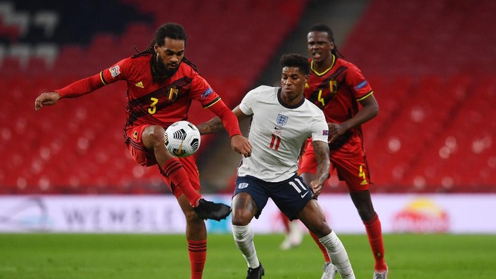 LONDON, ENGLAND - OCTOBER 11: Jason Denayer of Belgium  battles for possession with  Marcus Rashford of England  as Dedryck Boyata of Belgium looks on during the UEFA Nations League group stage match between England and Belgium at Wembley Stadium on October 11, 2020 in London, England. Football Stadiums around Europe remain empty due to the Coronavirus Pandemic as Government social distancing laws prohibit fans inside venues resulting in fixtures being played behind closed doors. (Photo by Neil Hall - Pool/Getty Images)