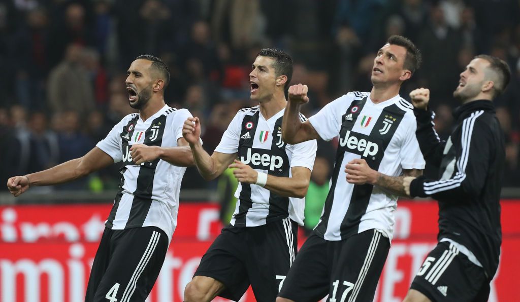 MILAN, ITALY - NOVEMBER 11:  (L-R) Medhi Benatia and Cristiano Ronaldo of Juventus FC celebrate a victory at the end of the Serie A match between AC Milan and Juventus at Stadio Giuseppe Meazza on November 11, 2018 in Milan, Italy.  (Photo by Marco Luzzani/Getty Images)