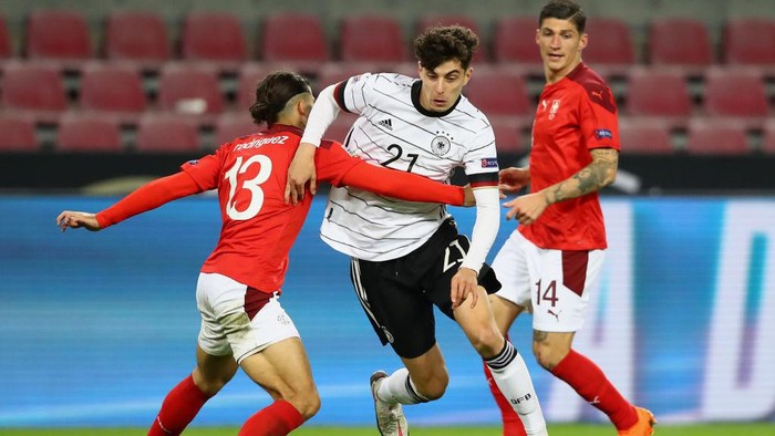 COLOGNE, GERMANY - OCTOBER 13: Kai Havertz of Germany is challenged by Ricardo Rodriguez of Switzerland during the UEFA Nations League group stage match between Germany and Switzerland at RheinEnergieStadion on October 13, 2020 in Cologne, Germany. Football Stadiums around Europe remain empty due to the Coronavirus Pandemic as Government social distancing laws prohibit fans inside venues resulting in fixtures being played behind closed doors. (Photo by Martin Rose/Getty Images)