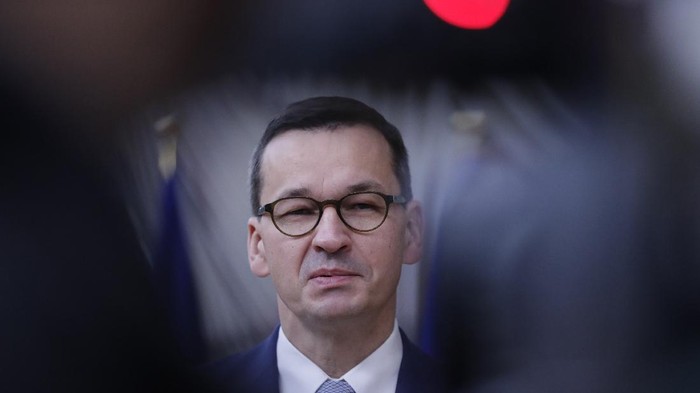 Polands Prime Minister Mateusz Morawiecki speaks on camera as he arrives for an EU summit at the European Council building in Brussels, Friday, Oct. 2, 2020. European Union leaders will be assessing the state of their economy and the impact of the coronavirus pandemic on it during their final day of a summit meeting. (Olivier Hoslet, Pool via AP)