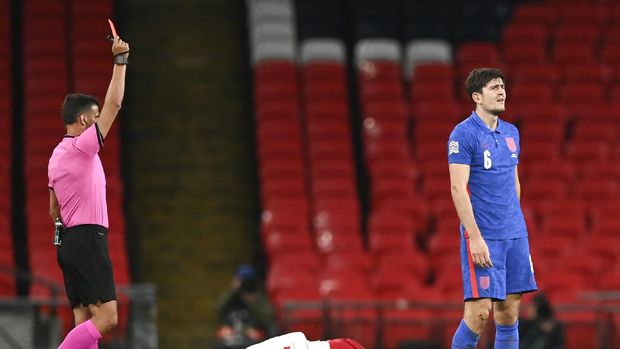 England's Harry Maguire, right, reacts as he is shown a red card by referee Jesus Gil Manzano, left, during the UEFA Nations League soccer match between England and Denmark at Wembley Stadium in London, England, Wednesday, Oct. 14, 2020. (Daniel Leal-Olivas/Pool via AP)