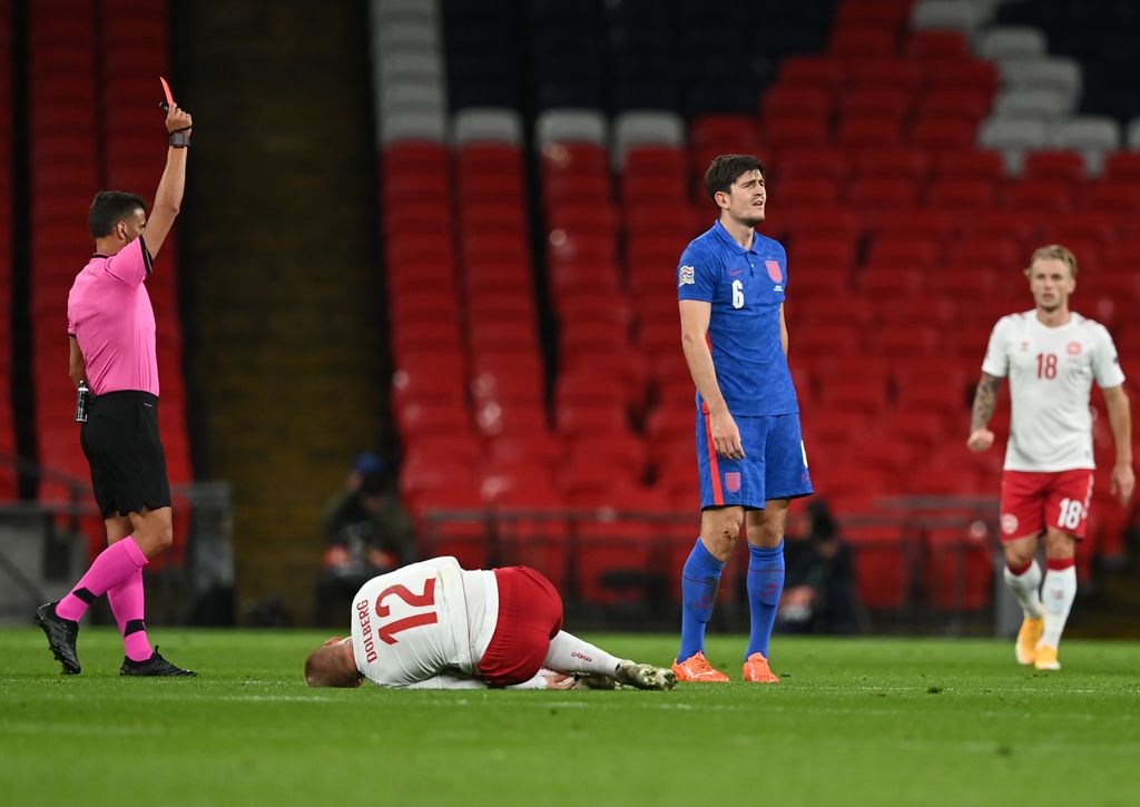 LONDON, ENGLAND - OCTOBER 14: Harry Maguire of England is shown the red card after getting a second yellow card during the UEFA Nations League group stage match between England and Denmark at Wembley Stadium on October 14, 2020 in London, England. Football Stadiums around Europe remain empty due to the Coronavirus Pandemic as Government social distancing laws prohibit fans inside venues resulting in fixtures being played behind closed doors. (Photo by Daniel Leal Olivas - Pool/Getty Images)