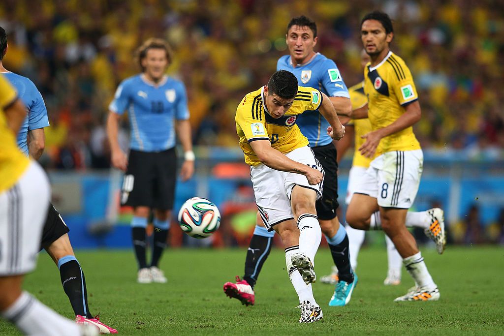 RIO DE JANEIRO, BRAZIL - JUNE 28:  James Rodriguez of Colombia shoots and scoores his team's first goal during the 2014 FIFA World Cup Brazil round of 16 match between Colombia and Uruguay at Maracana on June 28, 2014 in Rio de Janeiro, Brazil.  (Photo by Julian Finney/Getty Images)