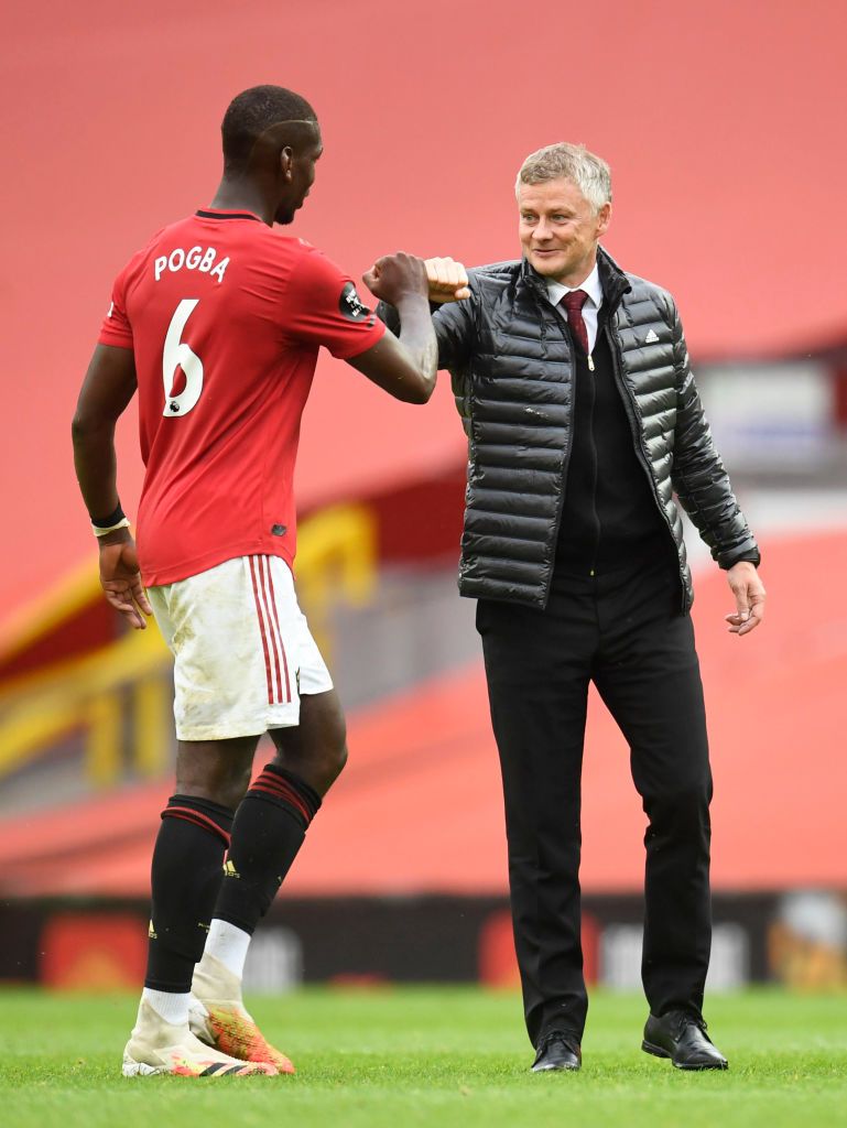 MANCHESTER, ENGLAND - JULY 04: Paul Pogba of Manchester United and Ole Gunnar Solskjaer, Manager of Manchester United fist bump following during the Premier League match between Manchester United and AFC Bournemouth  at Old Trafford on July 04, 2020 in Manchester, England. Football Stadiums around Europe remain empty due to the Coronavirus Pandemic as Government social distancing laws prohibit fans inside venues resulting in all fixtures being played behind closed doors. (Photo by Peter Powell/Pool via Getty Images)