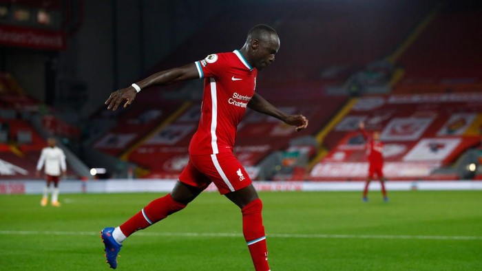LIVERPOOL, ENGLAND - SEPTEMBER 28: Sadio Mane of Liverpool celebrates after scoring his sides first goal during the Premier League match between Liverpool and Arsenal at Anfield on September 28, 2020 in Liverpool, England. Sporting stadiums around the UK remain under strict restrictions due to the Coronavirus Pandemic as Government social distancing laws prohibit fans inside venues resulting in games being played behind closed doors. (Photo by Jason Cairnduff - Pool/Getty Images)