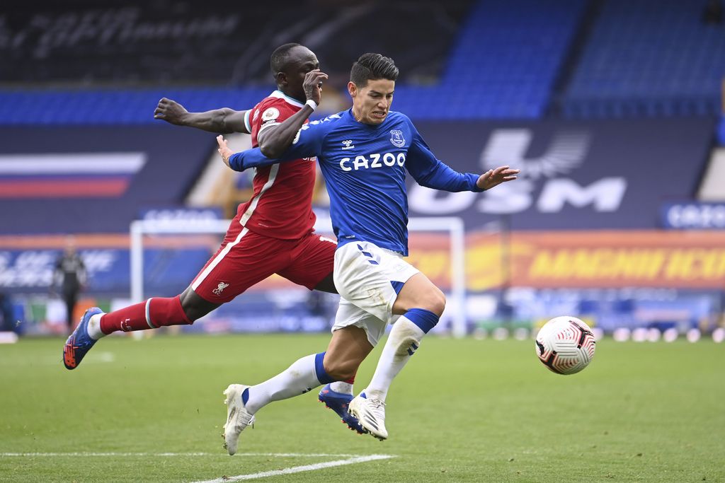 Everton's James Rodriguez, right, competes for the ball with Liverpool's Sadio Mane during the English Premier League soccer match between Everton and Liverpool at Goodison Park stadium, in Liverpool, England, Saturday, Oct. 17, 2020. (Laurence Griffiths/Pool via AP)