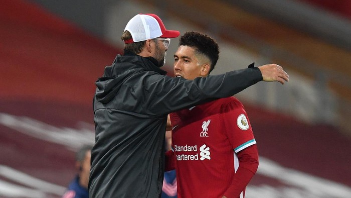LIVERPOOL, ENGLAND - SEPTEMBER 28: Jurgen Klopp, Manager of Liverpool embraces Roberto Firminho during the Premier League match between Liverpool and Arsenal at Anfield on September 28, 2020 in Liverpool, England. Sporting stadiums around the UK remain under strict restrictions due to the Coronavirus Pandemic as Government social distancing laws prohibit fans inside venues resulting in games being played behind closed doors. (Photo by Paul Ellis - Pool/Getty Images)
